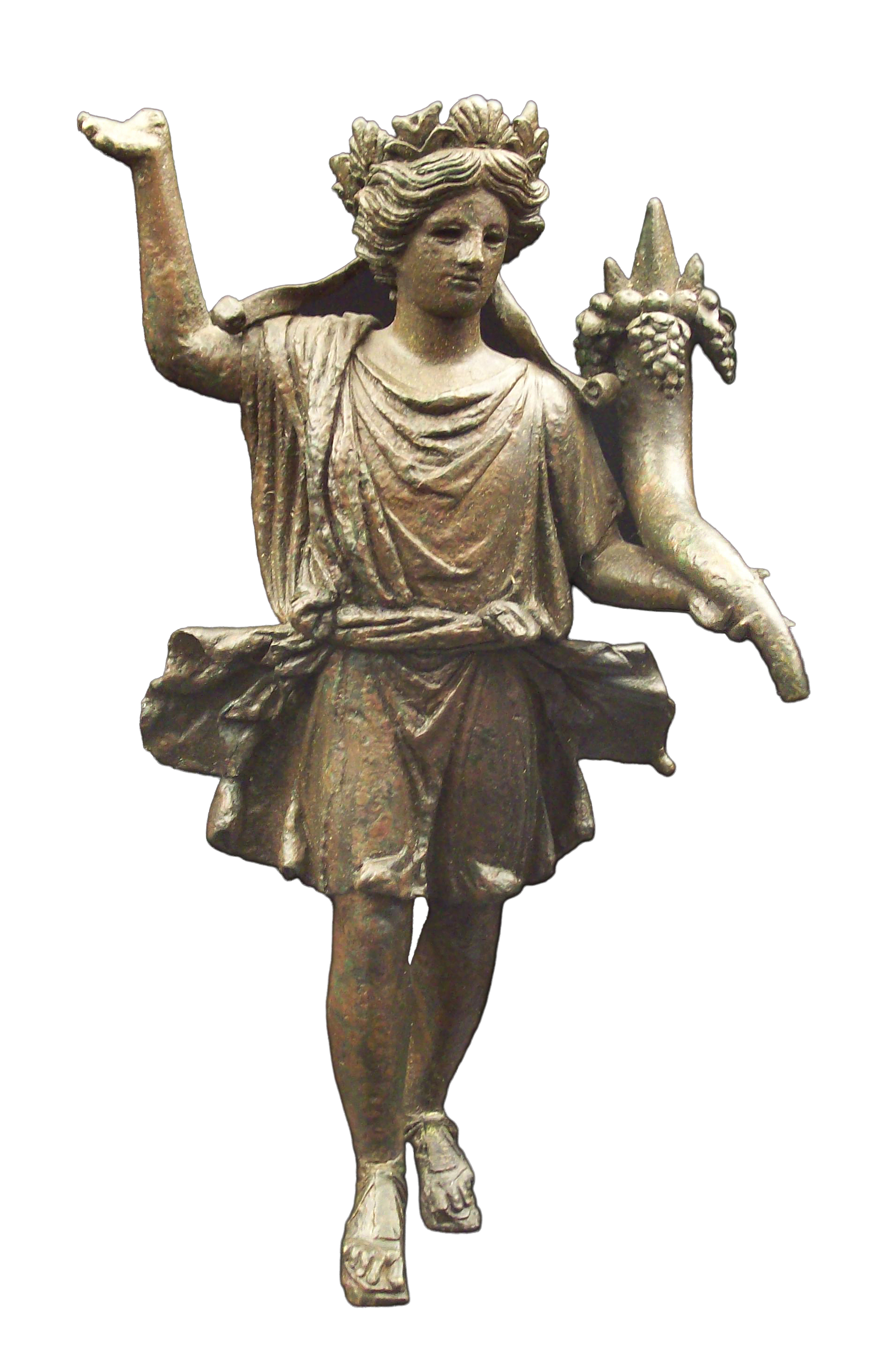Roman bronze statuette of Lar (household deity) against black background. Figure depicts young man in short draped tunic with curled hair and wreath crown, left arm raised in gesture, right hand holding cornucopia (horn of plenty) overflowing with grapes or fruit. Small winged creature (genius or putto) sits on his right shoulder holding spiked ornamental object. Figure wears sandals and stands in contrapposto pose. Patina shows age and oxidation of bronze metal. Inscription at top reads 'dii familiares lares.'